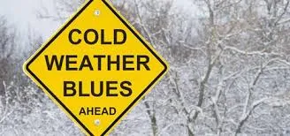 A yellow sign that says cold weather blues ahead.