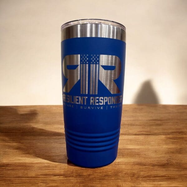 20 oz insulated tumbler with The Resilient Responder mug Sitting on counter.