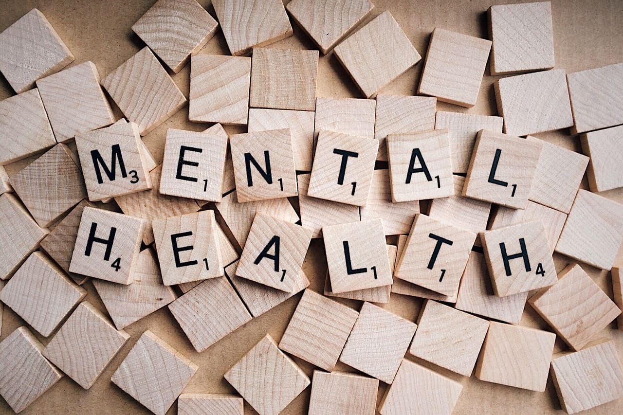 A pile of wooden blocks that spell out mental health.